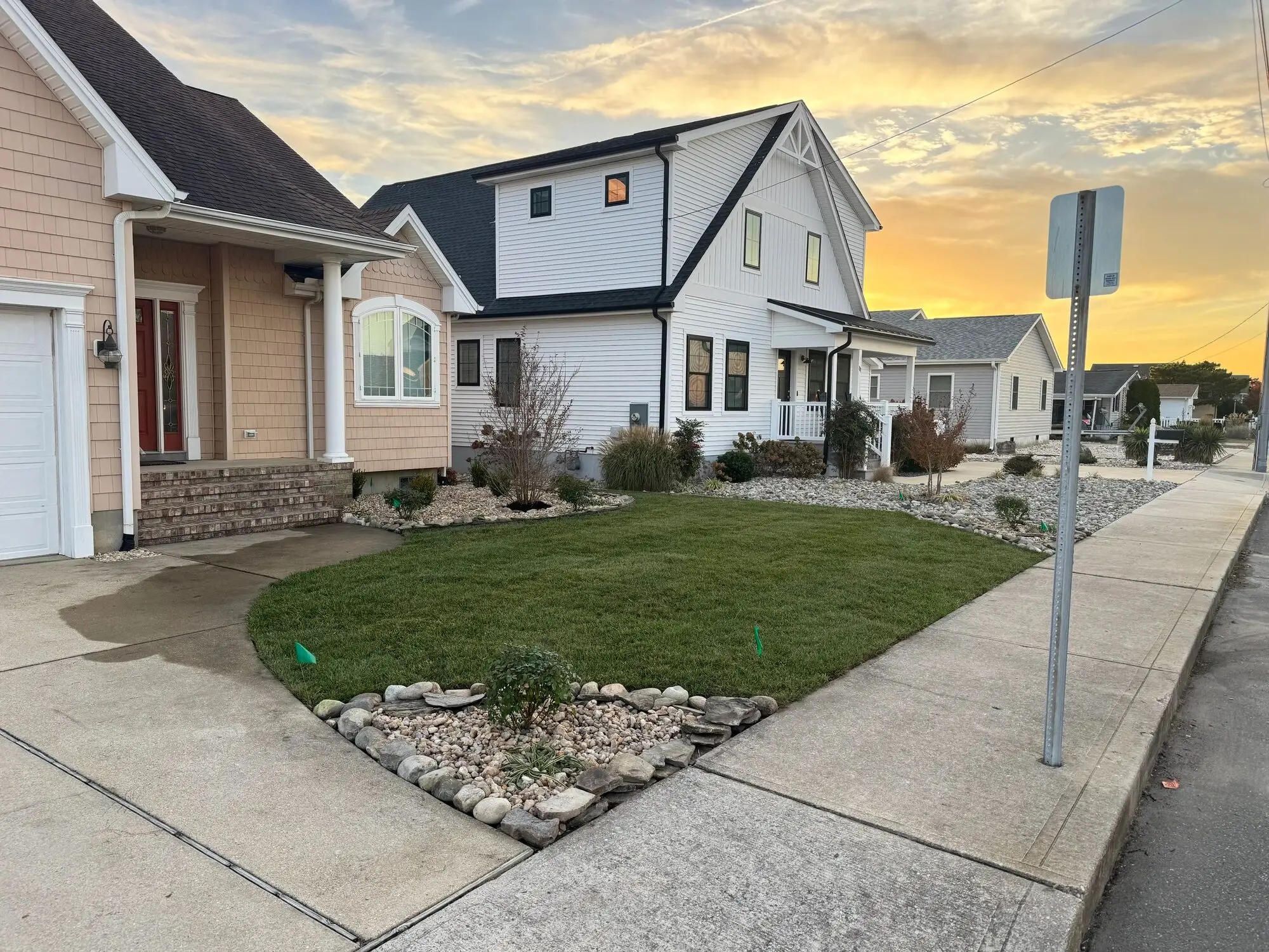 Freshly landscaped front lawn and stone bed at sunset in coastal Delaware